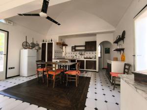 a kitchen with a table and chairs in a room at Villa Jeko in Lampedusa