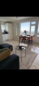 a living room with a couch and a table at Stylish seafront flat in Hove in Brighton & Hove