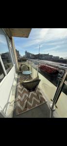 a balcony with a chair and a table on a building at Stylish seafront flat in Hove in Brighton & Hove