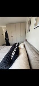 a black and white umbrella laying on a bed at Stylish seafront flat in Hove in Brighton & Hove +2 photos