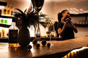 a woman taking a picture of a bar with a glass of wine at Tribe Bungalows, Bwejuu, Zanzibar in Bwejuu