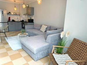 a living room with a couch and a table at Blue Home in Burgas