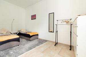 a room with two beds and a mirror on the wall at Apartament Grodzka Centrum in Jelenia Góra