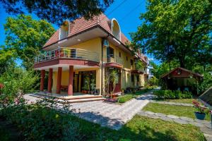a yellow house with a red roof at Casa Meyra in Jupiter