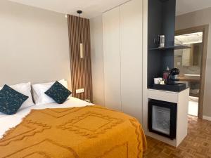 a bedroom with a bed and a fire place at Raiano Guest House in Monção