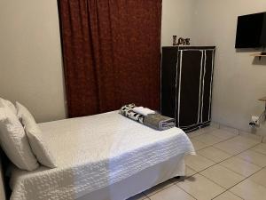a hotel room with a camera on a bed at M J GuestHouse in Boksburg +4 photos