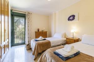 a bedroom with two beds and a balcony at Floridamar in Jávea +26 photos