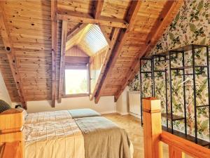 a bedroom with a bed in a room with wooden ceilings at El Puyal de Benas in Benasque
