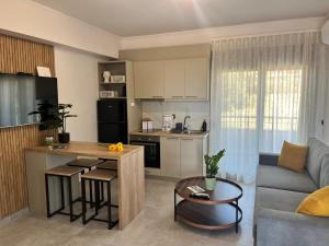 a kitchen and living room with a couch and a table at La casa in Chios