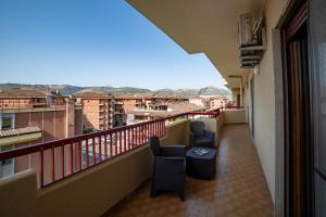 a balcony with two chairs and a table at B&B Benvenuti al centro in Caserta