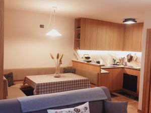 a kitchen with a table with a vase on it at Casina dello Spinale in Madonna di Campiglio