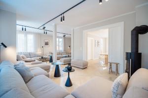 a living room with white furniture and a couch at Ferienhaus Beatus ille in Kolpinsee