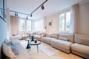 a living room with a large couch and tables at Ferienhaus Beatus ille in Kolpinsee