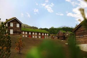 a group of buildings with grass on the roofs at Bjerkeløkkja Bed and Breakfast in Oppdal