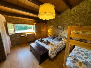 a bedroom with a bed in a stone wall at Ca l'Esclatat in Santa María de Palautordera +63 photos