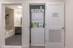 a kitchen with a white refrigerator in a room at Opulence in Olive with Free Parking, 2 BR 2 baths Suite, 5 beds and Sleeps 8 in Orange +26 photos