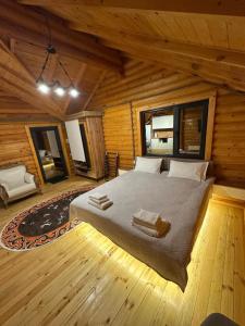 a bedroom with a bed in a log cabin at Лесник in Cholpon-Ata