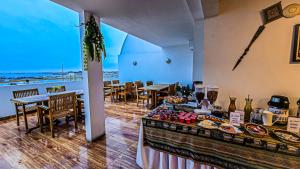 a food stand in a room with tables and chairs at Hotel Riviera Inka Paracas in Paracas
