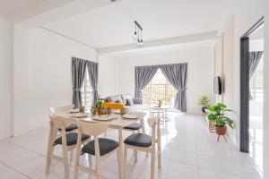 a white living room with a table and chairs at Perfect for Families & Friends, Retreat Clover Home 2-20 in Brinchang