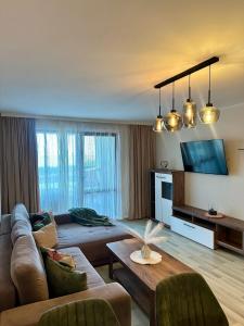 a living room with a couch and a table at La Veranda Apartment, complex Carpe Diem, Free Parking & Swimignpool in Balchik