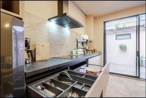 a kitchen with a sink and a stove at Casa Mitho in Bogotá