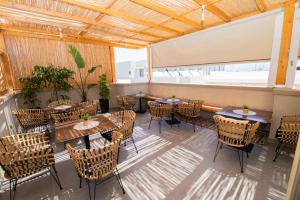 a patio with tables and chairs in a restaurant at Lunar Hotel Modern Boutique in Hersonissos