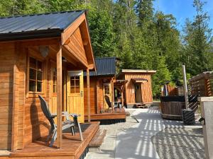 a group of wooden cabins on a patio at Garden Bay Hideaway - Glamping & RV in Garden Bay