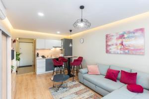 a living room with a couch and a kitchen at Sunset Resort 113 in Fonyód +14 photos