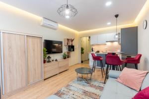 a living room with a couch and a table at Sunset Resort 113 in Fonyód