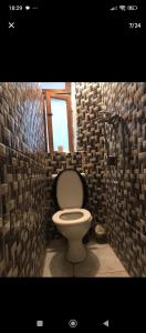 a bathroom with a toilet in a brick wall at Artistic house in the middle of Essaouira in Essaouira