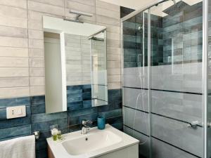 a bathroom with a sink and a shower at Simone's House in Tuglie