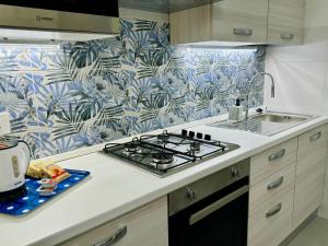 a kitchen with a stove top oven next to a sink at Simone's House in Tuglie +21 photos