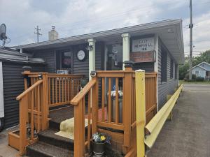 a small building with a porch and a store at Hotel O East Hemphill Burton-Flint in Burton