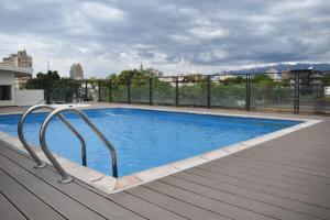a swimming pool on top of a building at Gran Hotel Dakar in Mendoza