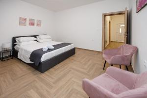 a bedroom with a bed and two chairs at Dvori dida Drage in Zaton +39 photos