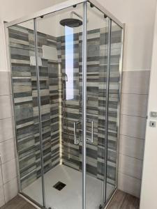 a shower with glass doors in a bathroom at HOUSE on sunday LUNA in Crotone +14 photos