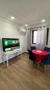 a living room with a red table and a tv at Sania torres in Sania Torres