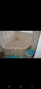 a bathroom with a bath tub and a toilet at Peace Accommodation B&B in Silver Sands