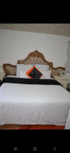 a bed with a white comforter and pillows at Peace Accommodation B&B in Silver Sands