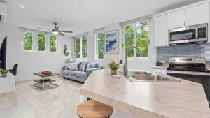 a kitchen with a sink and a living room at Casa Angelica Apt 103 steps to Sandy Beach in Rincon