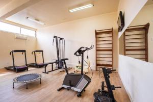 a gym with several treadmills and machines in a room at Hotel Suárez Campo Bom in Campo Bom