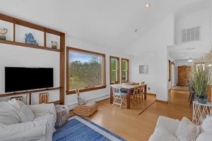 a living room with a couch and a tv at Beach front oasis - Hot tub - Sleeps 7 in Keansburg