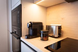 a kitchen with a coffee maker and a microwave at Levander 2 in Králiky +4 photos