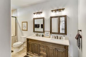 a bathroom with a sink and a toilet and mirrors at Porch, Fire Pit Pine View Retreat in Lakeside! in Lake of the Woods +20 photos
