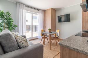 a living room with a couch and a table at Suites Deluxe By Roque in Vigo