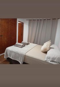 a bedroom with a bed with towels on it at Caprichos de la Selva Puerto Iguazú in Puerto Iguazú +10 photos