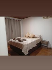 a bedroom with a bed with towels on it at Caprichos de la Selva Puerto Iguazú in Puerto Iguazú