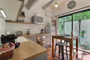 a kitchen with a table and a counter top at The Provencal Escape - Swimming Pool & Nature in Trets