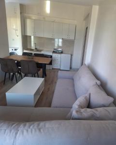 a living room with a couch and a table at Pockovi Apartments in Star Dojran +1 photo