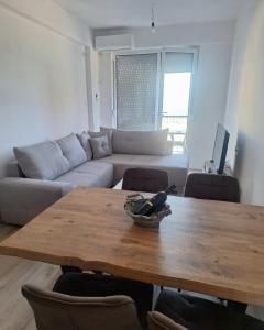 a living room with a table and a couch at Pockovi Apartments in Star Dojran